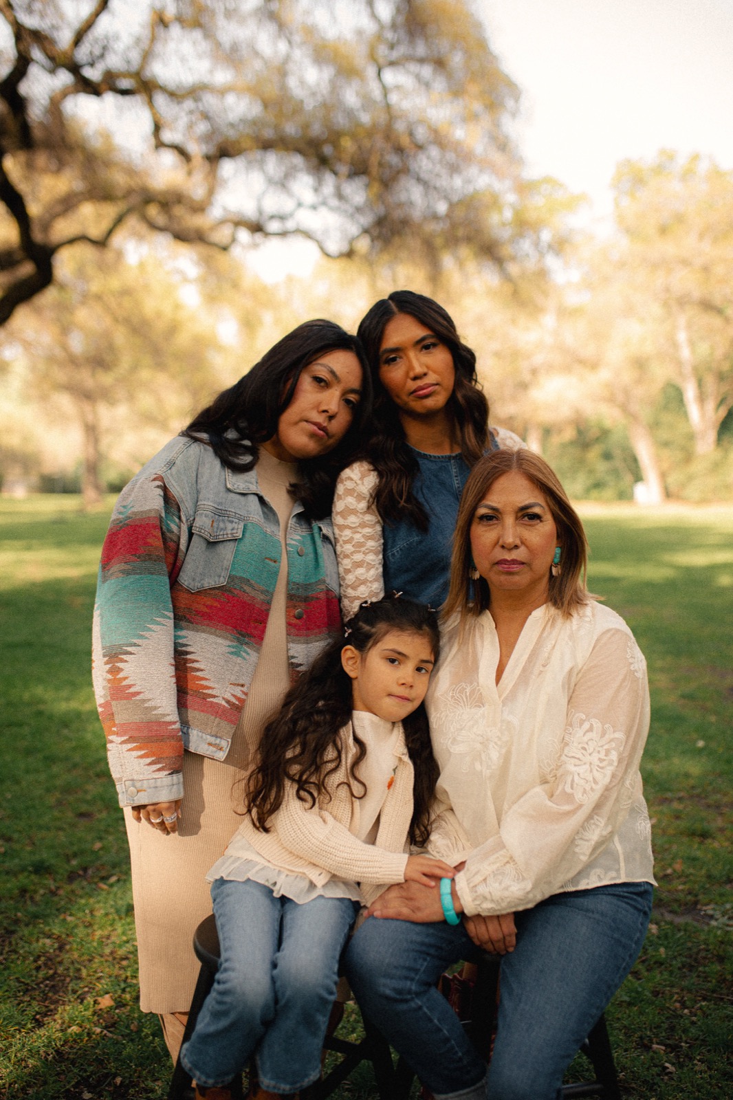 Three generations of a family in a park at golden hour